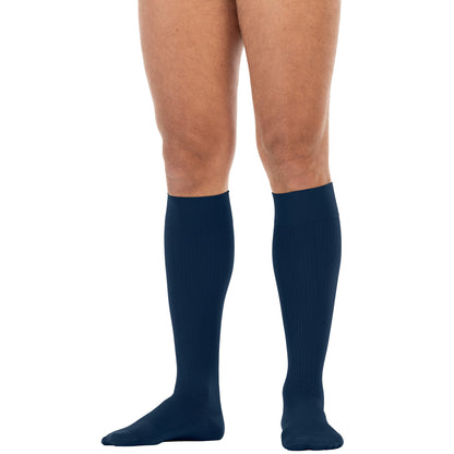 Navy blue knee-high socks worn by a person on a white background